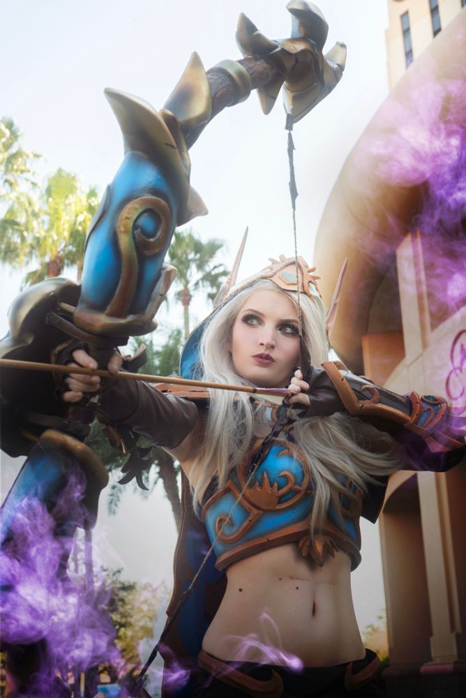 Dark Lady cosplaying Ranger General sylvanas Windrunner from world of Warcraft in a close up archery pose, her bow pointed and drawn to the left 