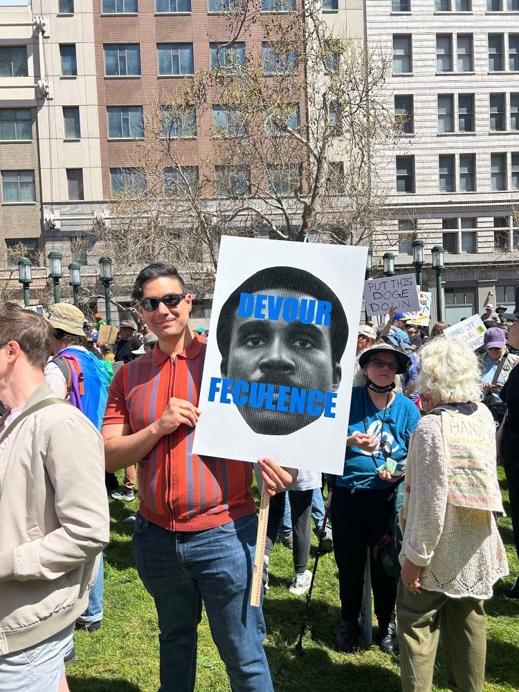 Protest sign that says, “Devour Feculence”.