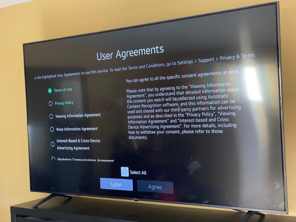A large TV open to the YouTube app, but with a long list of user agreements to a free to, such as Terms of Use, Privacy Policy, Voice Information agreement, etc