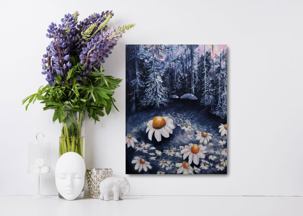 A painting in a limited color palette of blue, pink, white, and yellow has a close-up of daisies with a thick forest in the background. There is a vase of purple lilac to the left of the painting. 