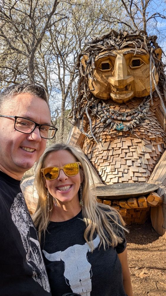 Portrait of my partner and me in front of the Dambo sculpture, "Malin's Fountain," at Pease Park, in Austin, TX.
