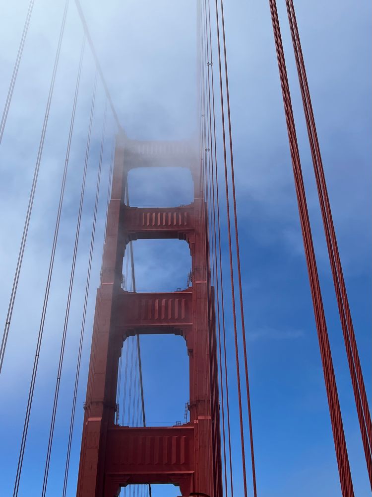 A close-up view of the Golden Gate Bridge in the fog