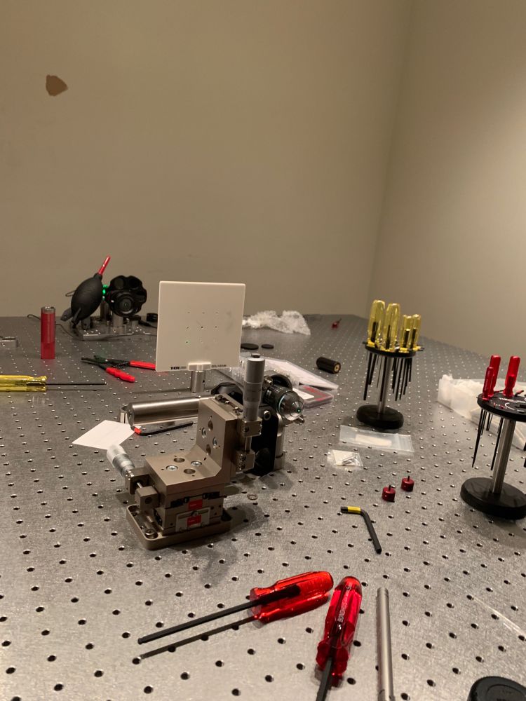 Building part of a microscope by aligning the laser using a series of mirrors on adjustable mounts 
