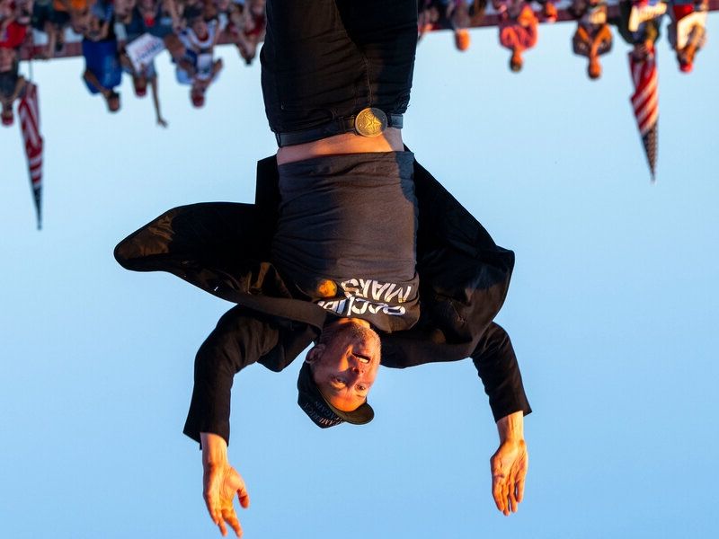 Elon jumping but the picture is upside down.