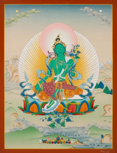 A thanga, sacred artwork of the deity green Tara. She is always depicted with her foot extended out, as if she is to leap right off the painting to help you. Her green color corresponded to the Tibetan wind element, which reinforces her swiftness in giving aid. In this painting she is depicted radiating light with one for her body which is adorned in jewels and one for her face. She sits on a multicolored lotus in this painting, emerging from a huge sea with mountains flanking it. Right beneath her offerings are presented