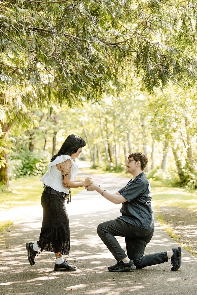 Joe proposing to his girlfriend on a forested path