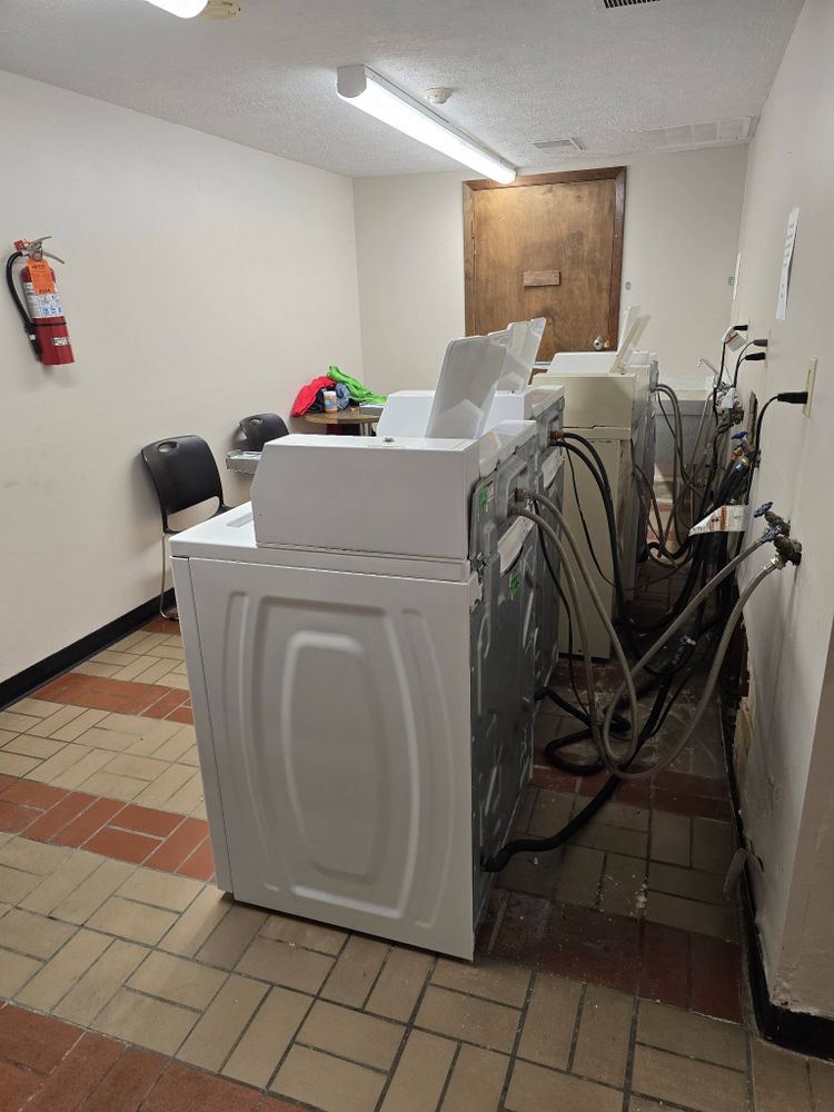 Photo of all washing machines pulled away from wall with visible hook ups