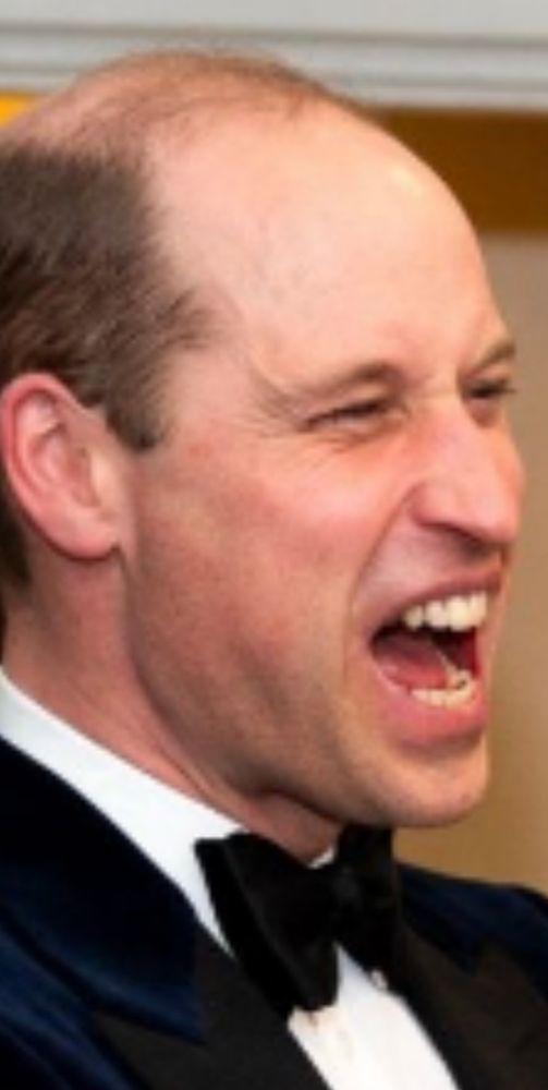 Close up of Prince William looking his least sexy in a tuxedo and black bow tie, possibly howling or barking angrily at a passing mail carrier