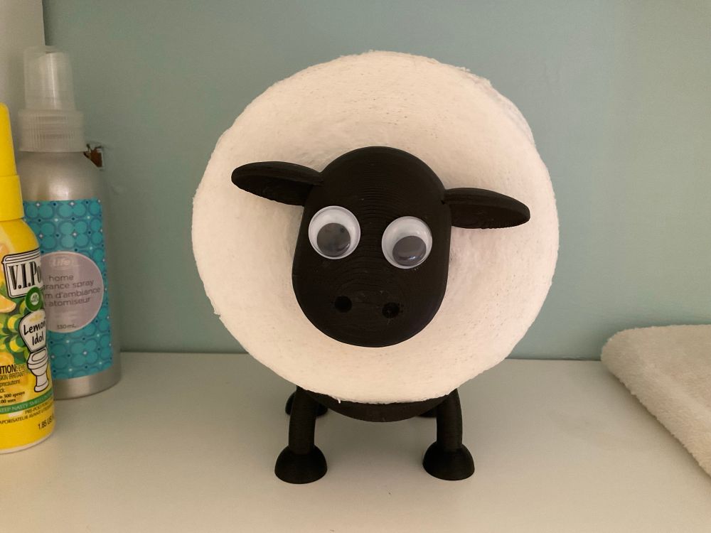 A sheep toilet paper holder