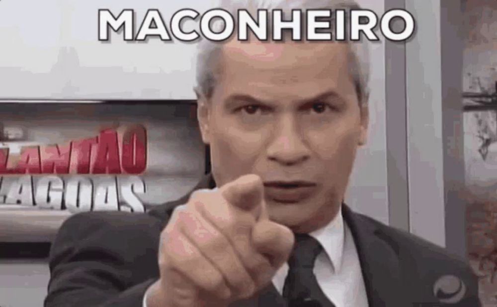 a man in a suit and tie is pointing his finger at the camera with the word maconheiro above him