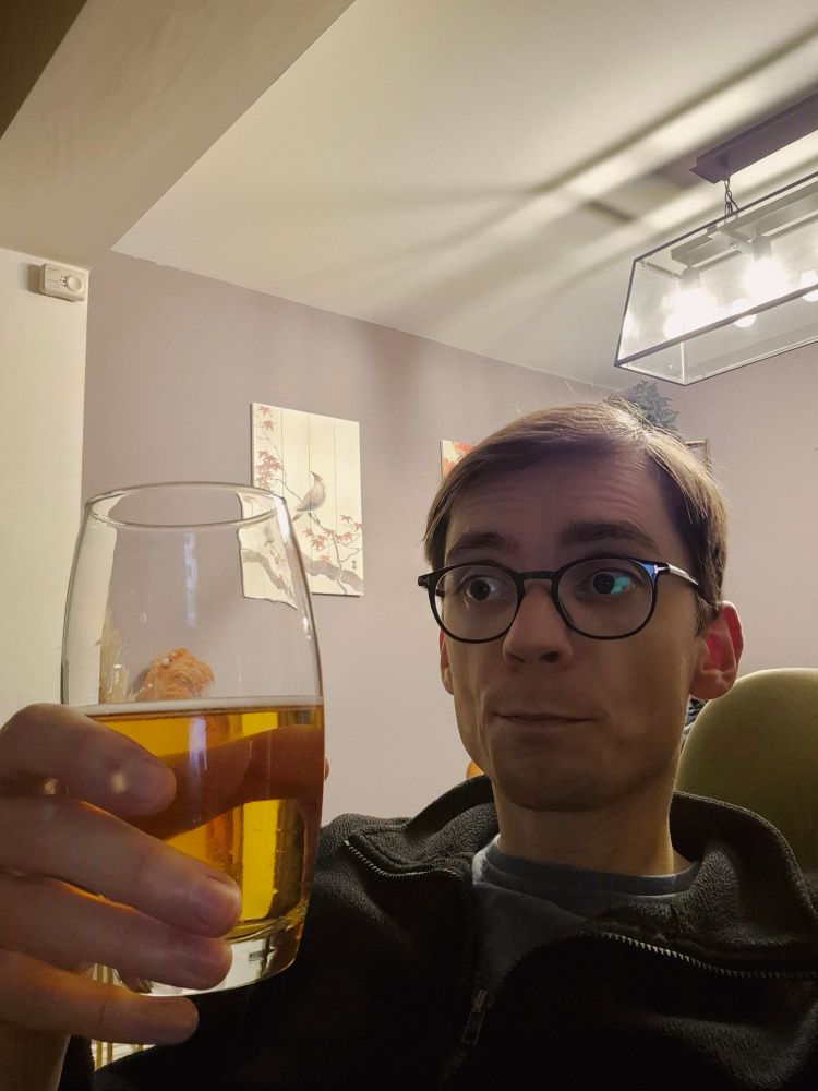 A selfie of me holding a glass of beer. 