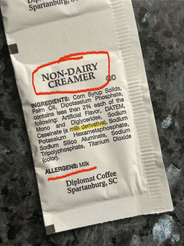Photo shows a Diplomat Coffee company non-dairy creamer packet, with the ingredients listed. This list includes sodium caseinate (a milk derivative) and the warning lists milk as an allergen in the products. 