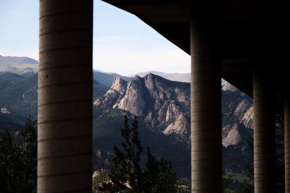 A mountain in Estes Park framed by pillars of a pedestrian bridge