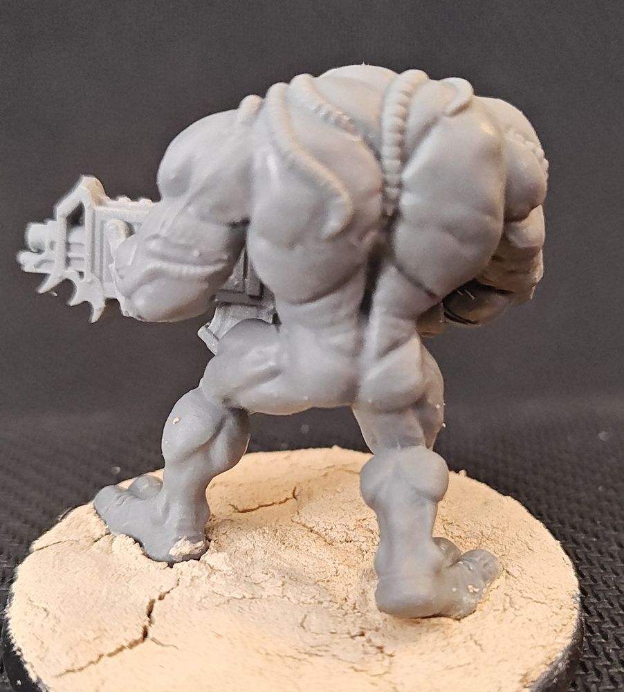 A close up of a miniature of a Razide monster from Warzone, centered on its butt.