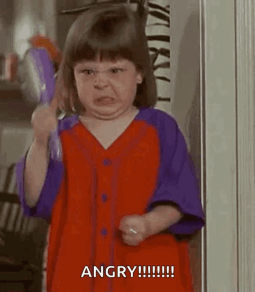 a little girl in a red and purple dress is brushing her hair with a brush .