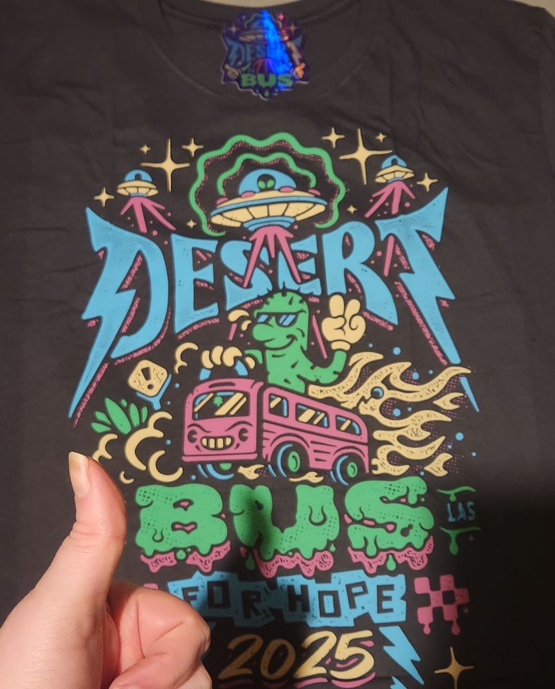 The 2025 Desert Bus T-Shirt, with a happy thumbs up.