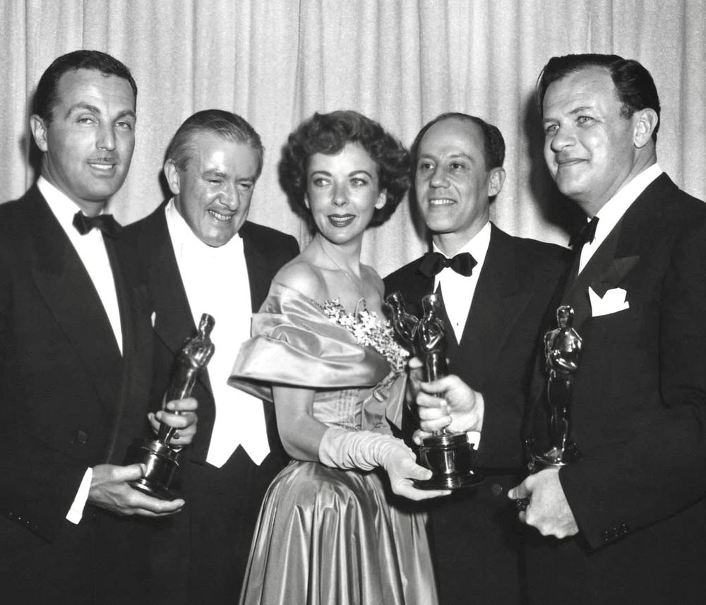 Original caption: “Backstage at the 1949 (22nd) Academy Awards ceremony, from left: Douglas Morrow, winner, Writing (Motion Picture Story)
(THE STRATTON STORY); presenter James Hilton; presenter Ida Lupino; Robert Pirosh, winner, Writing (Story and Screenplay)
(BATTLEGROUND); and Joseph L. Mankiewicz, winner, Directing and Writing (Screenplay) (A LETTER TO THREE WIVES).”