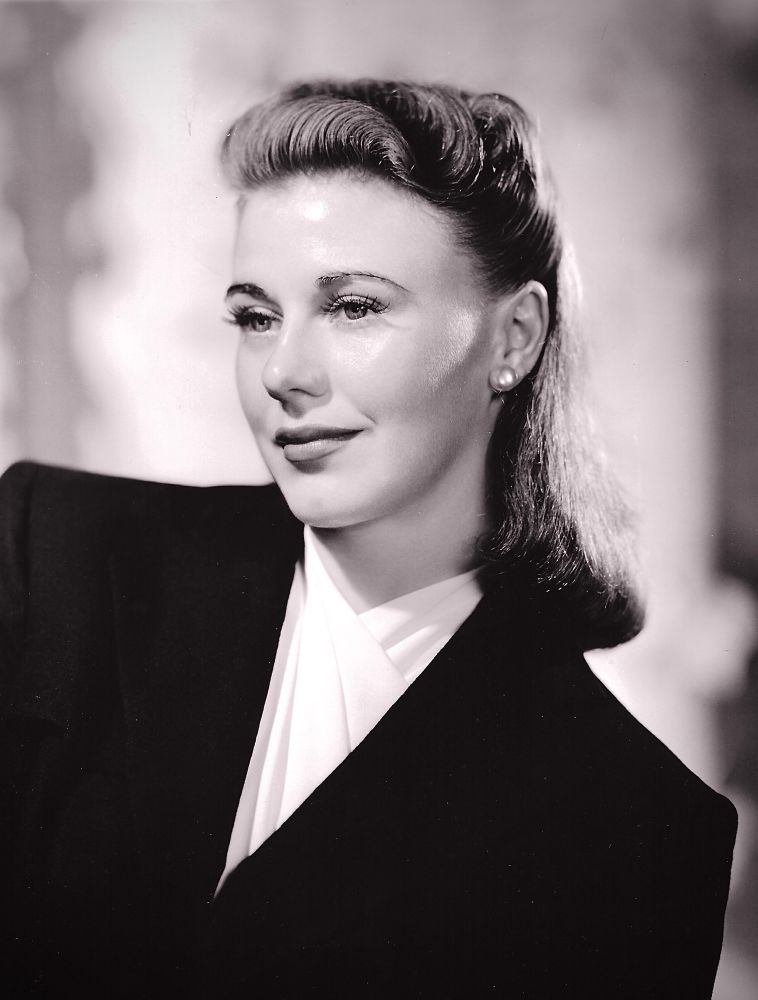 Glamour headshot of Rogers with dark hair