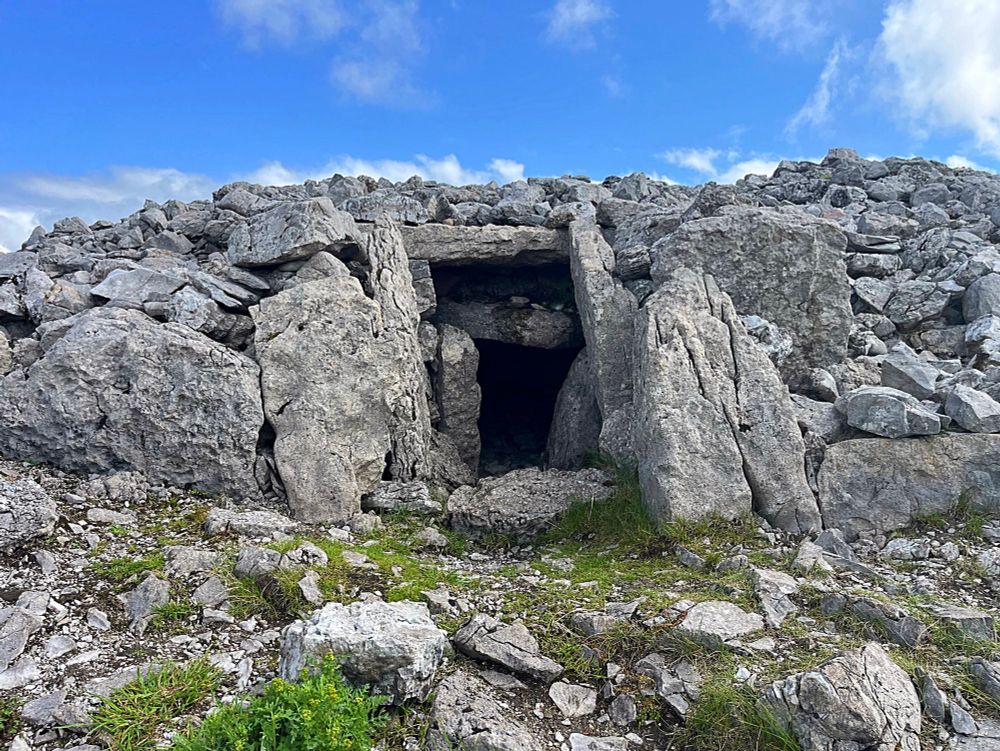 A photo of one of the Carrowkeel passage tombs. A grey stony doorway forms the portal into the mound.