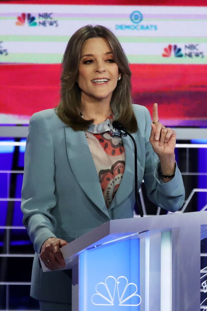 Marianne Williamson at a podium 