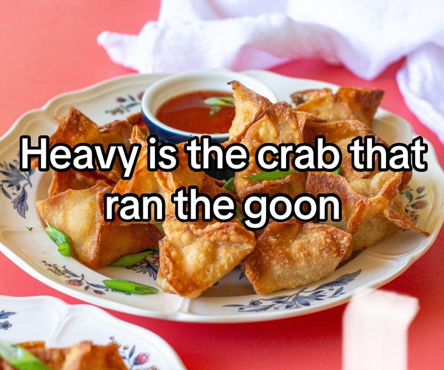Plate of crab rangoons with the text “heavy is the crab that ran the goon”