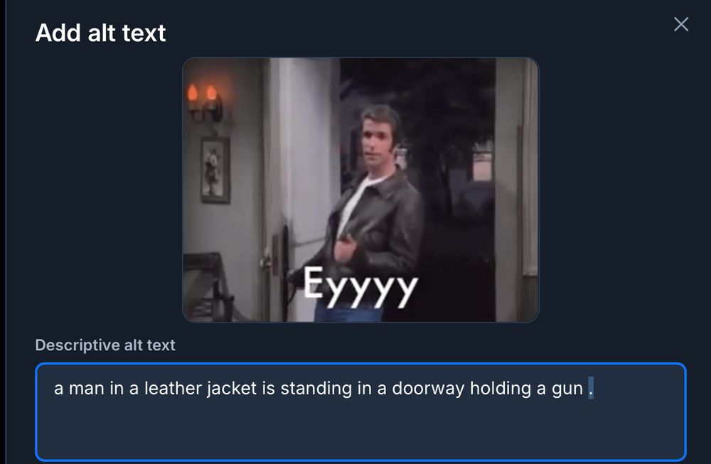 a  screenshot of a gif of the fonz standing in a doorway with auto-generated alt-text that says "a man in a leather jacket is standing in a doorway holding a gun"