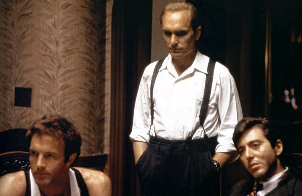 Godfather: Duvall, hands in pocket, stands behind Al Pacino and James Caan seated.