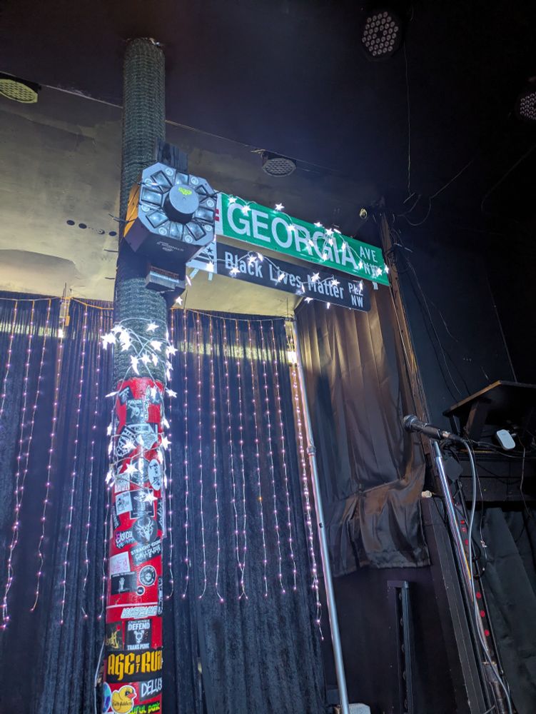 Post inside Simple Bar with "Georgia avenue" and "black lives matter plaza" signs