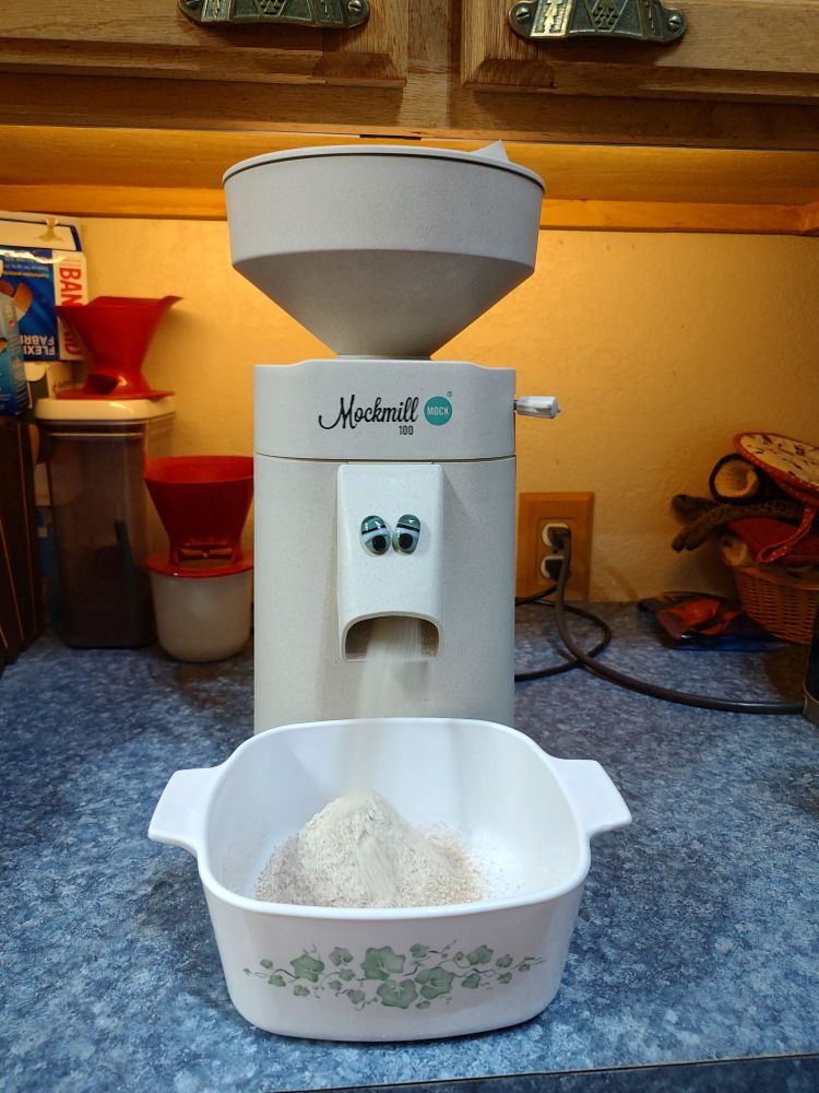 Mockmill in action with glued on eyeballs (looks like he's barfing out flour)