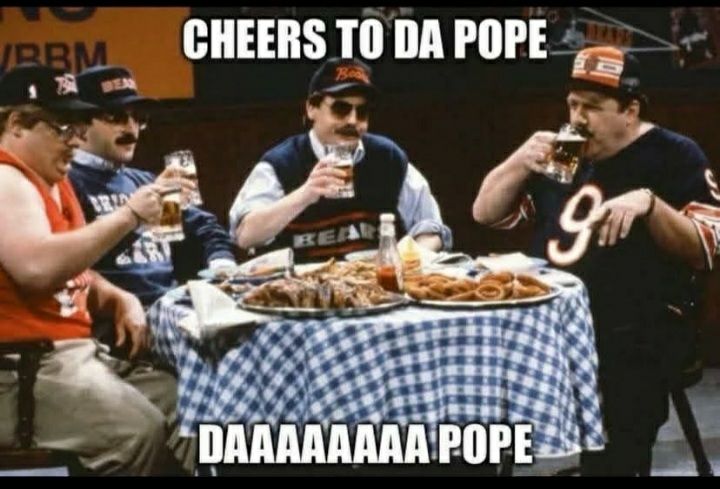 Says "Cheers to Da Pope, DAAAAAAAA Pope" shows SNL skit with table with 4 men drinking beers & wearing the Bears shirts in hats. 