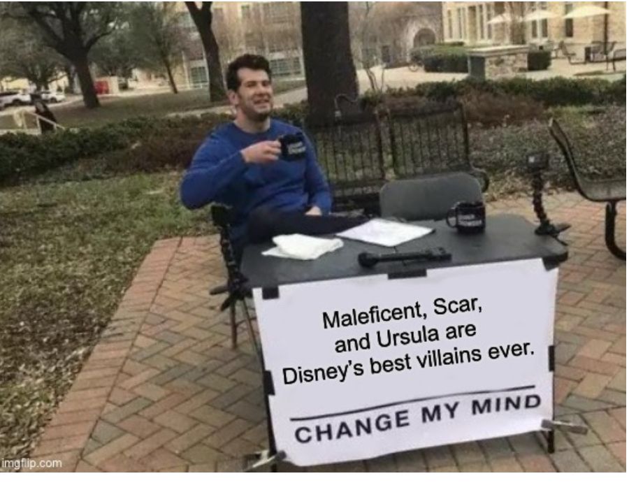 Meme shows man sitting behind a table in an urban park. Sign on front of table reads, “Maleficent, Scar, and Ursula are Disney’s best villains ever. Change my mind.”