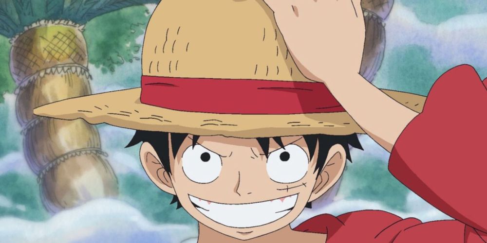 Luffy with his straw hat that doe not look like a crown of thorns and has a red sash around it but is not red.