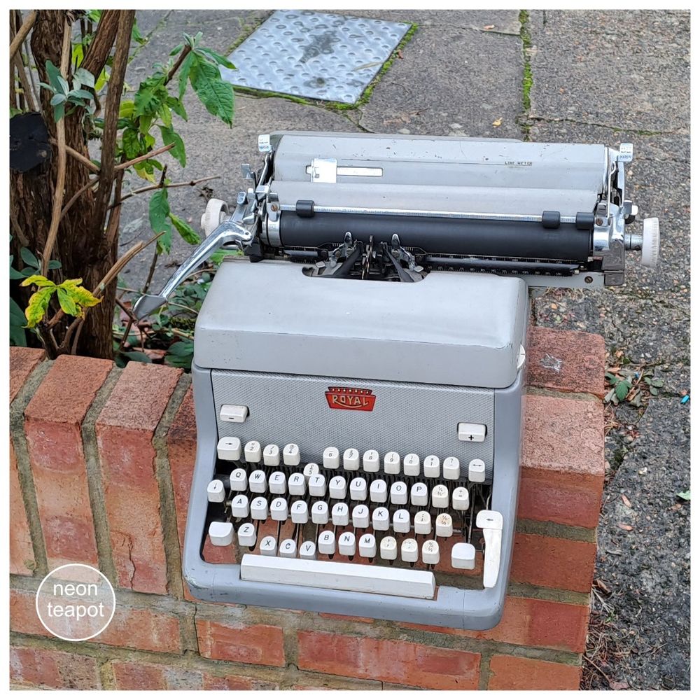 A photograph showing an old typewriter left on top of a low brick wall. The typewriter is grey and made by a company called Royal. It's been left at the bottom of the drive and can be taken away by anyone who wants it. It was gone later in the day.