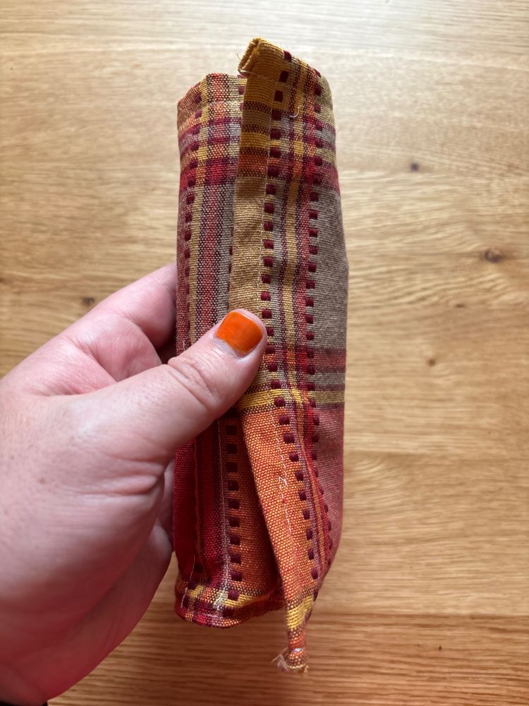 red yellow and orange roll up makeup bag all rolled up