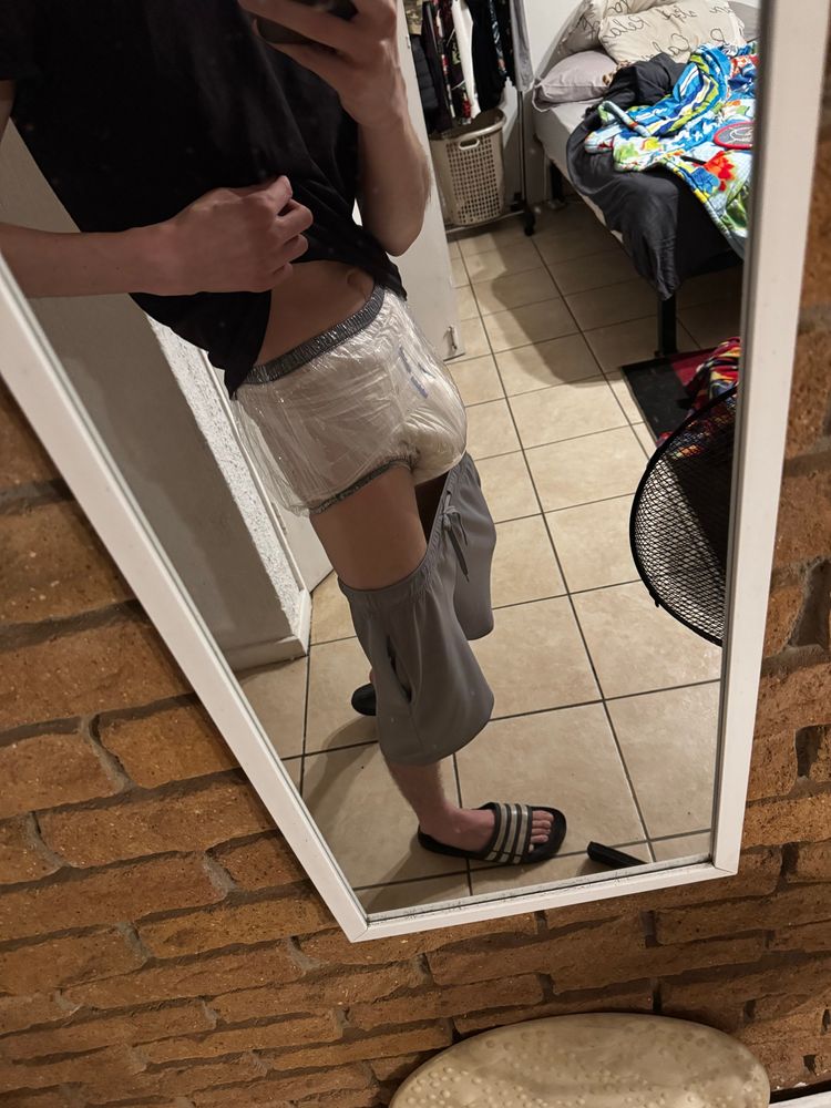 ABDL Diaper boy in chastity, a diaper, and plastic pants. 
