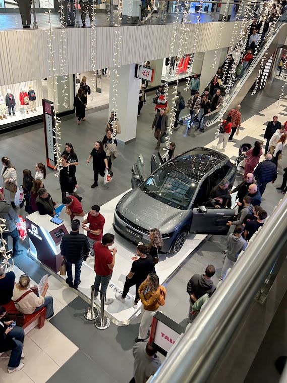 A silver Zeekr 7X in the middle of a crowded mall in Thessaloniki, Greece