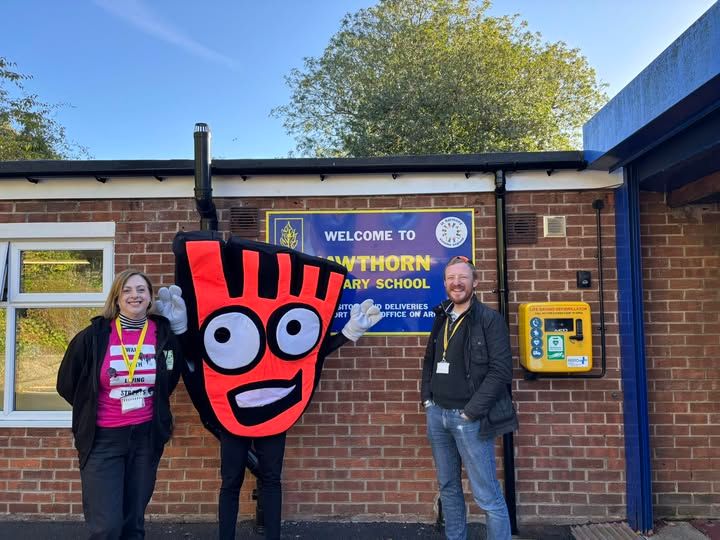 Colin Ferguson pictured in front of Hawthorn Primary School with the Living Streets mascot, Strider.