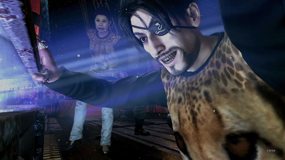 Screenshot from Like a Dragon Yakuza Pirate. Majima opening a treasure chest with Etsuko in the background both wearing the iconic cheetah sweater.