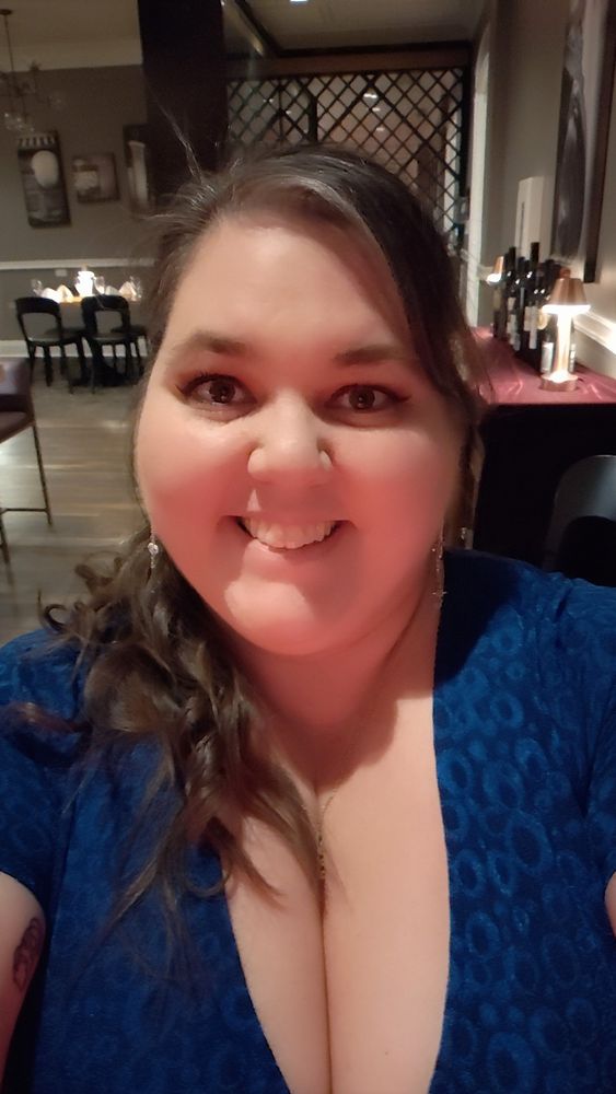 Girl with long brown hair in a blue dress