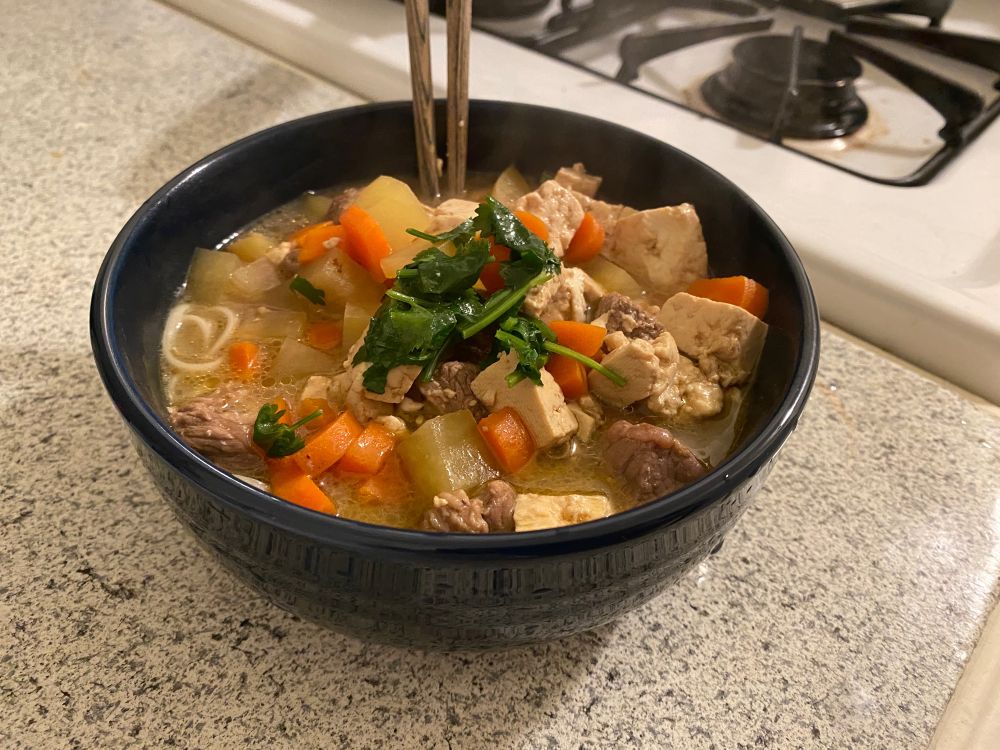 Noodle soup with lamb, carrot, tofu, and potato