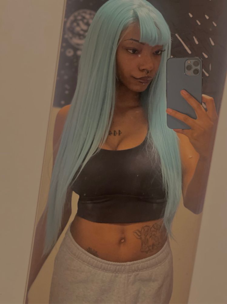 black girl with blue/green hair in mirror selfie