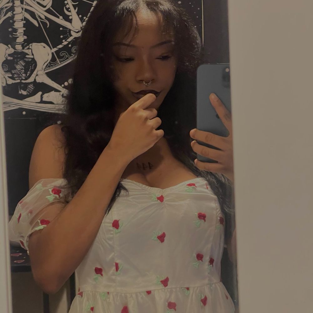 just an alt black lover girl taking a mirror selfie wearing a rose dress