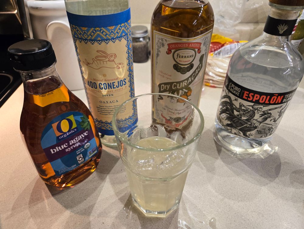 Blue agave, Mezcal, Dry Curacao, and Tequila behind a freshly made Margarita
