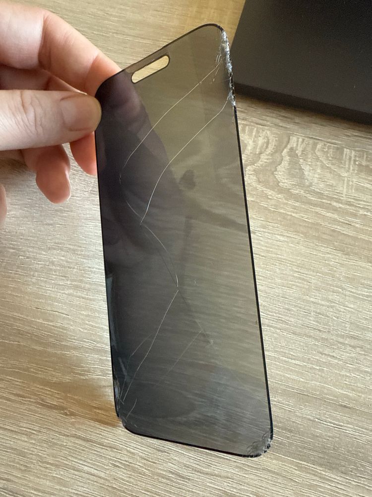 Damaged screen protector with multiple cracks and damages on the edges