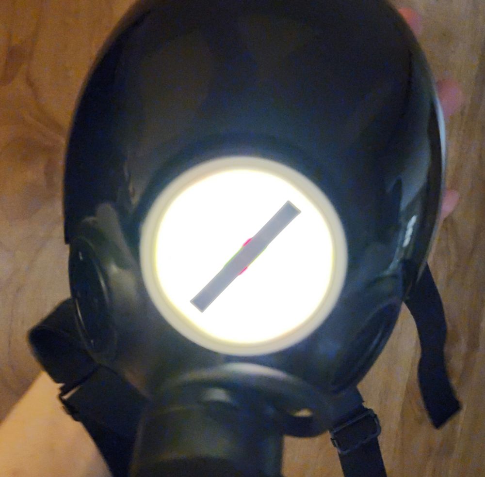 Literally just the Xantronix Heavy Manufacturing Concern's logo 3d printed for an MSA gasmask light. The colors are not visible on the camera when its lit up.