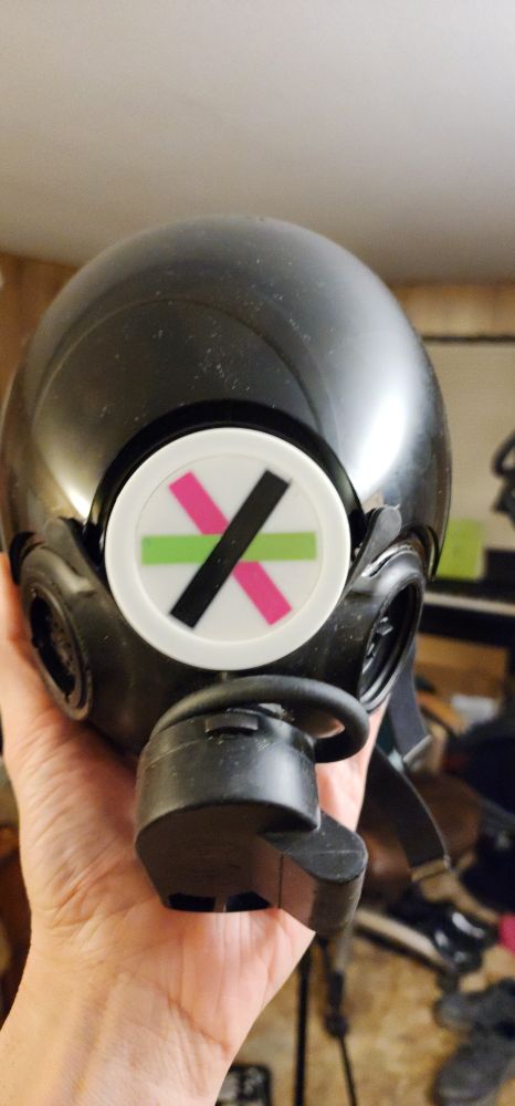 Literally just the Xantronix Heavy Manufacturing Concern's logo 3d printed for an MSA gasmask light. This one is actually in the gasmask.