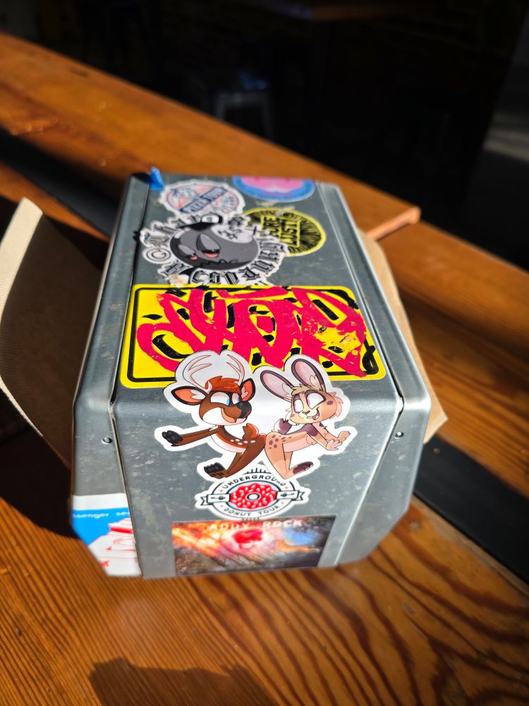 Napkin holder with a furry sticker. They're totally touching butts.