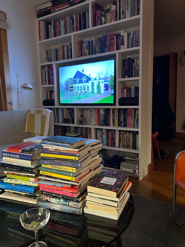 A view of my living room table and front book shelf, a tv set inside of it. 