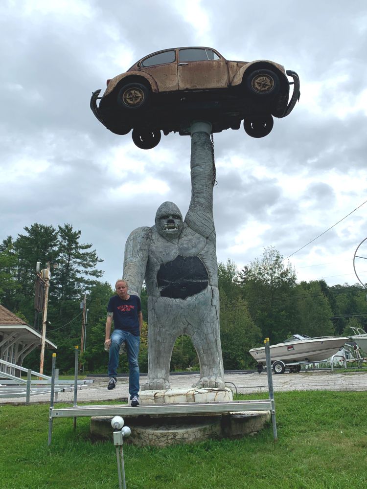 A big gorilla made out of concrete, I guess, with an inexplicable hole in the stomach area. One arm is holding up a rusted old VW bug, the other is outstretched and forms a sort of seat, in which I am sitting.