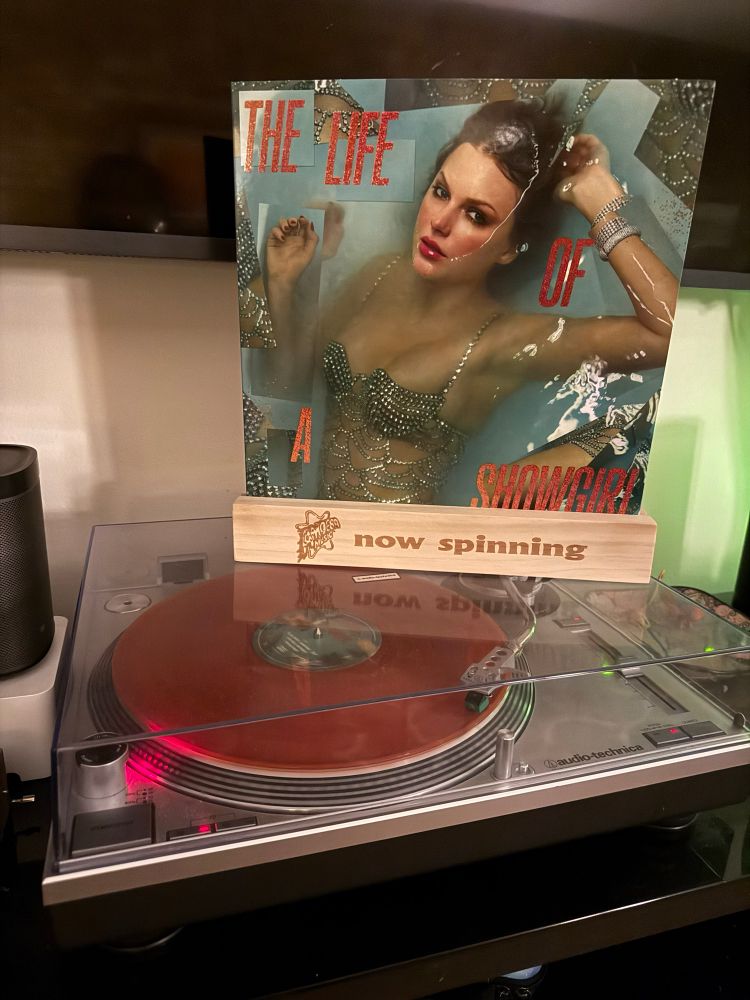 Orange glitter vinyl copy of the new Taylor Swift record The Life Of A Showgirl spinning in its release day on an Audio Technica turntable.